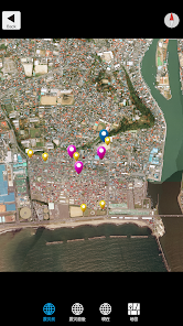 Satellite map of a coastal city showing clustered colored pins marking locations near the river. It looks like an interactive map with markers in pink, purple, and yellow near the waterfront.